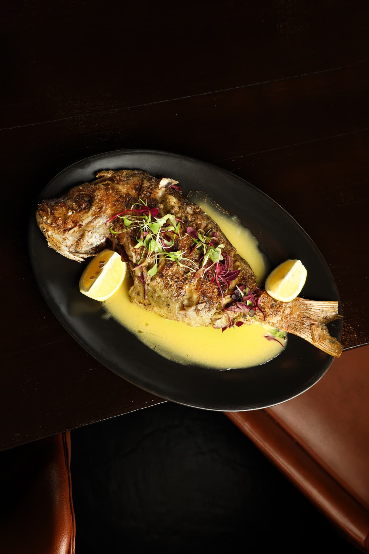 Whole grilled fish with lemon butter sauce at MIRA